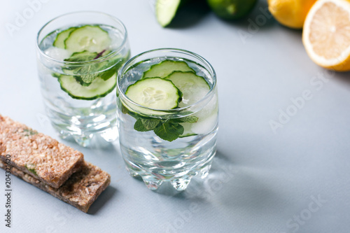 Detox water infused with sliced cucumber and springs of mint, copy space