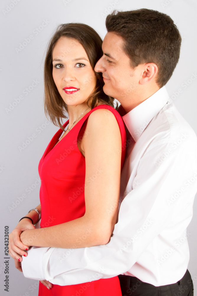 young couple in love make a hug in grey background young couple in love make a hug in grey background