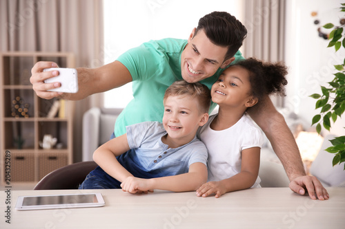 Young man taking selfie wit...