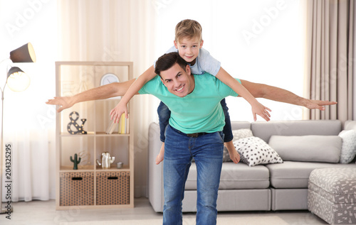 Young man playing with litt...