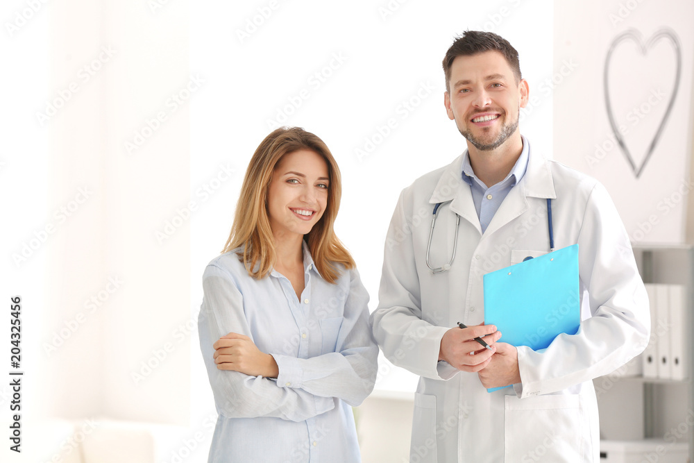 Doctor with female patient in consultation room Doctor with female patient in consultation room