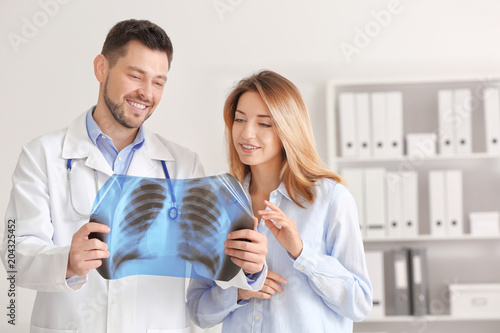 Doctor consulting female pa...