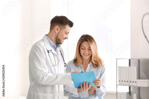 Doctor consulting female pa...