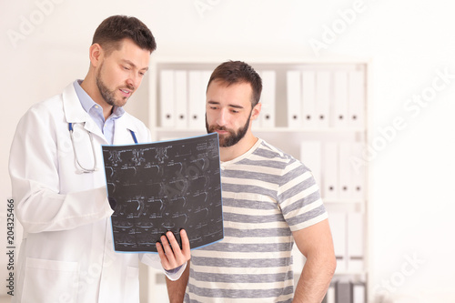 Doctor consulting male pati...