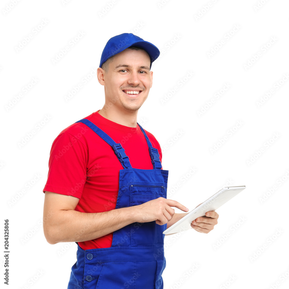 Young plumber with tablet computer on white background