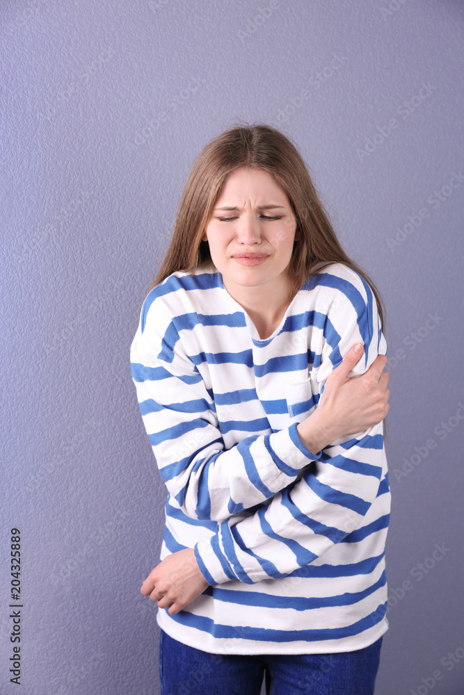Young woman having heart attack on color background Young woman having heart attack on color background