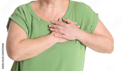 Mature woman having heart attack on white background