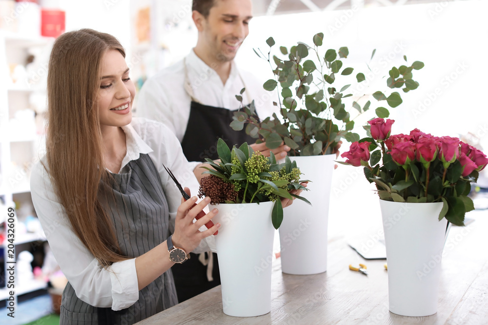 Young florists making beautiful bouquet in flower shop Young florists making beautiful bouquet in flower shop