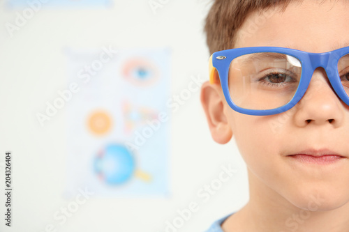 Cute little boy with glasses visiting ophthalmologist