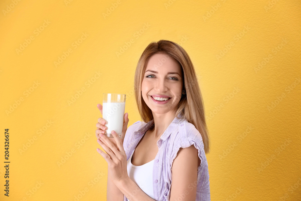 Beautiful young woman drinking milk on color background Beautiful young woman drinking milk on color background