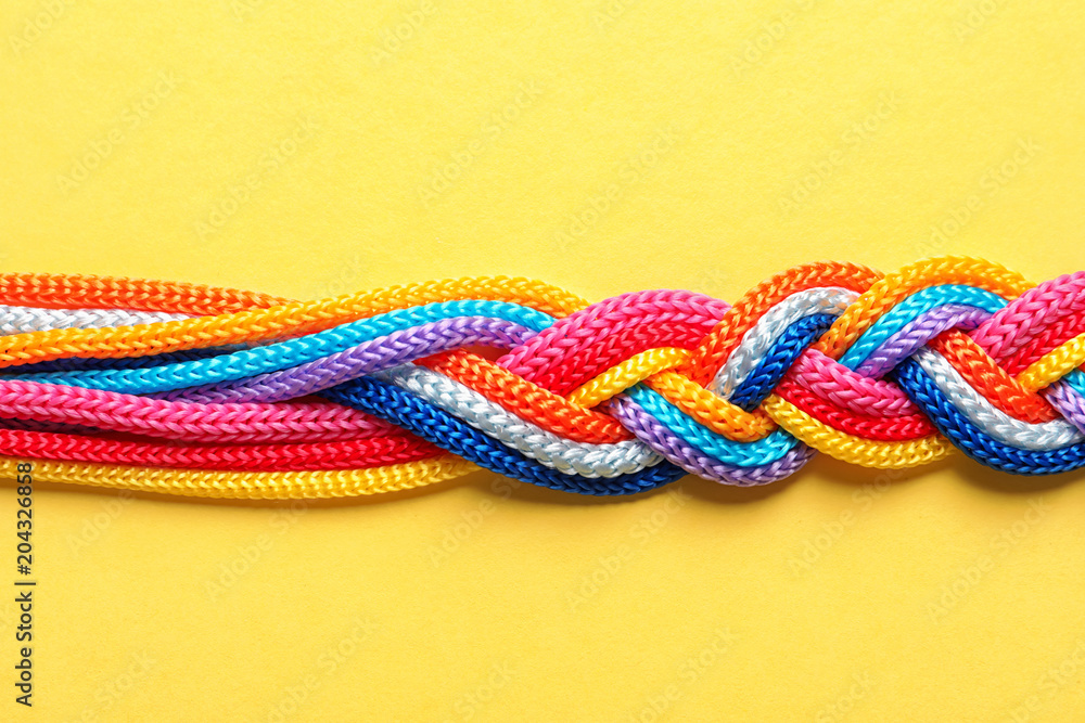 Braided ropes on color background, top view. Unity concept Braided ropes on color background, top view. Unity concept