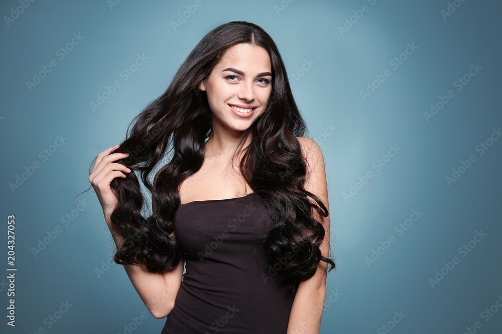Portrait of beautiful model with gorgeous curly hair on color background Portrait of beautiful model with gorgeous curly hair on color background