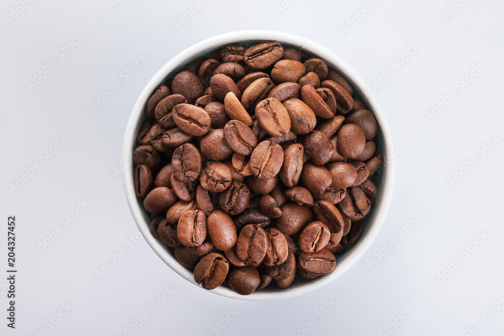paper cup filled with coffee beans
