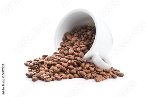 ceramic cup filled with roasted coffee beans