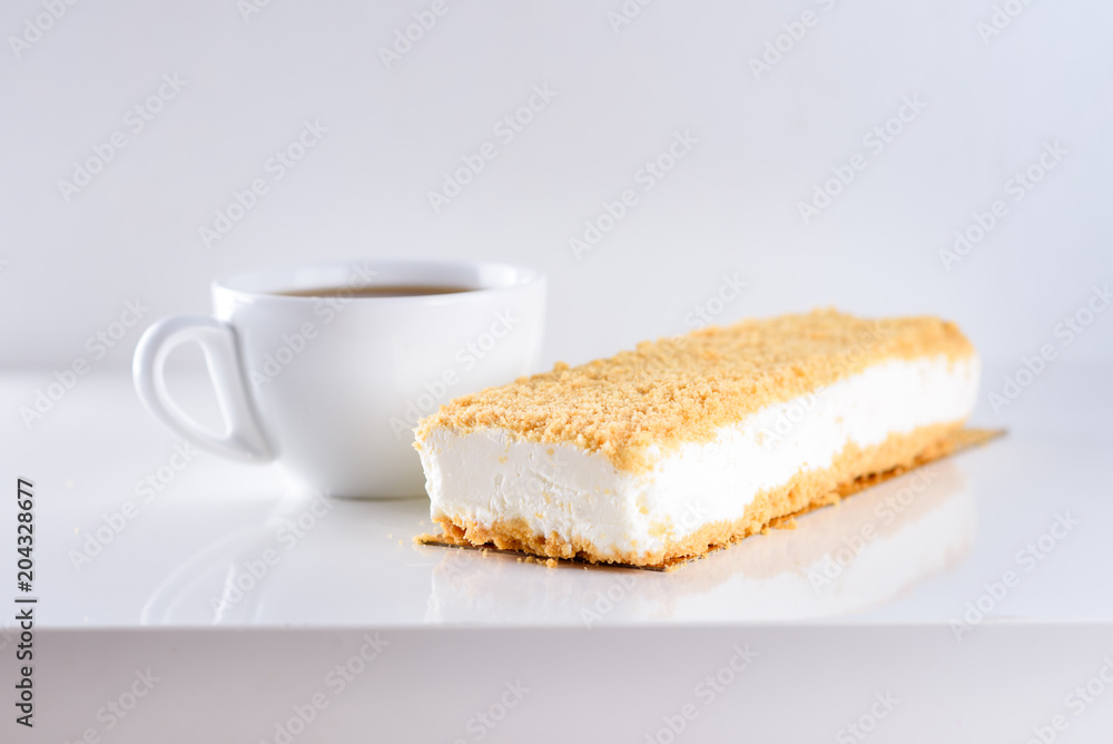 Cheesecake topped with Crumb and cup of coffee on white background-greatest breakfast. White icecream cake on wooden table. Shavuot, holiday, lifestyle, happy moments concept. Cheesecake topped with Crumb and cup of coffee on white background-greatest breakfast. White icecream cake on wooden table. Shavuot, holiday, lifestyle, happy moments concept.