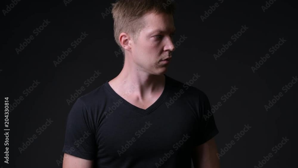 Young handsome man against black background Young handsome man against black background
