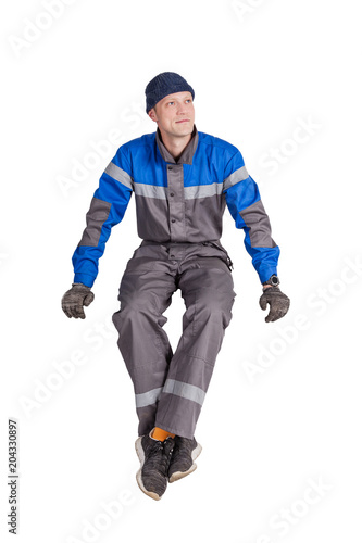 Portrait of a beautiful construction worker, foreman or repairman sitting in a white interior