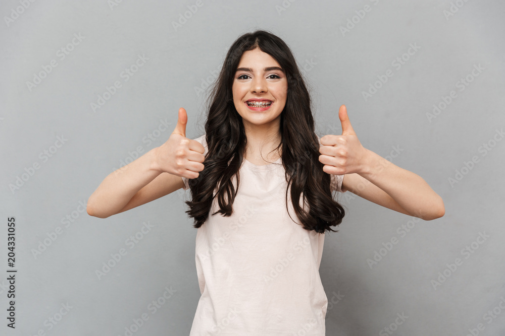 Young lady make thumbs up gesture. Young lady make thumbs up gesture.