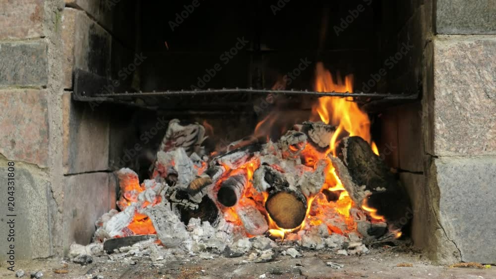 fire burns in a brick grill, burning barbecue fire burns in a brick grill, burning barbecue