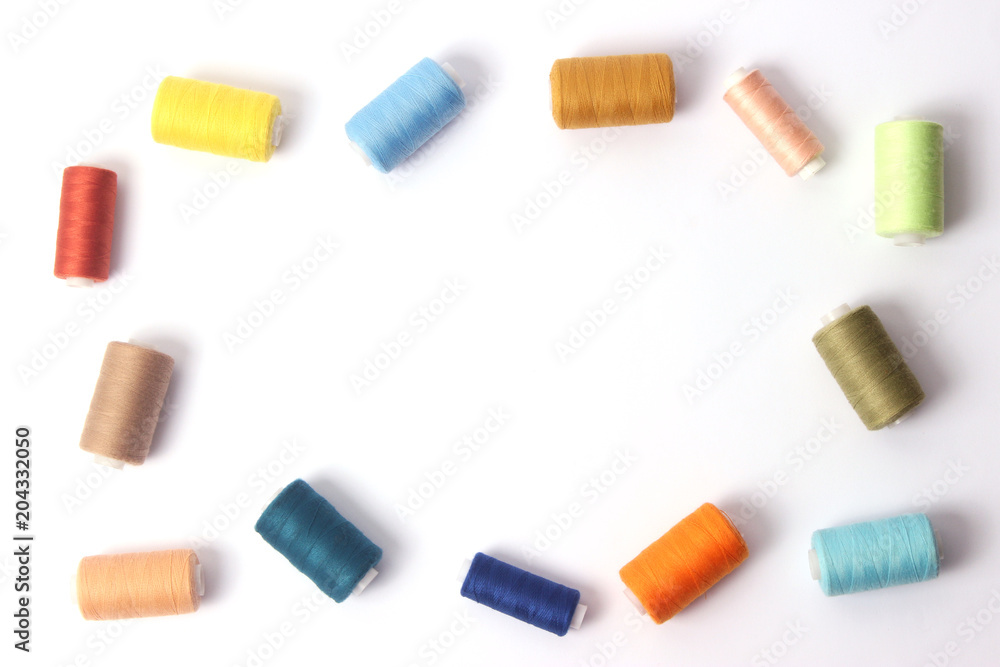 Sewing thread of different colors on a white background Sewing thread of different colors on a white background