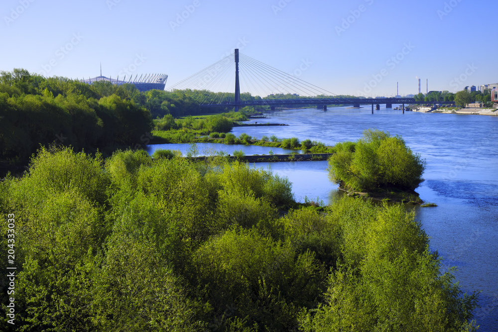 Warsaw, Poland - Panoramic view of the Vistula river and south districts of Warsaw with National Stadium and Swietokrzyski bridge Warsaw, Poland - Panoramic view of the Vistula river and south districts of Warsaw with National Stadium and Swietokrzyski bridge