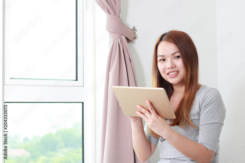 Fototapeta premium Young woman using tablet at home.