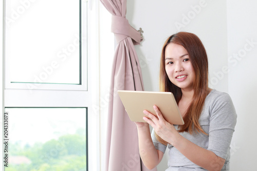 Young woman using tablet at home.
