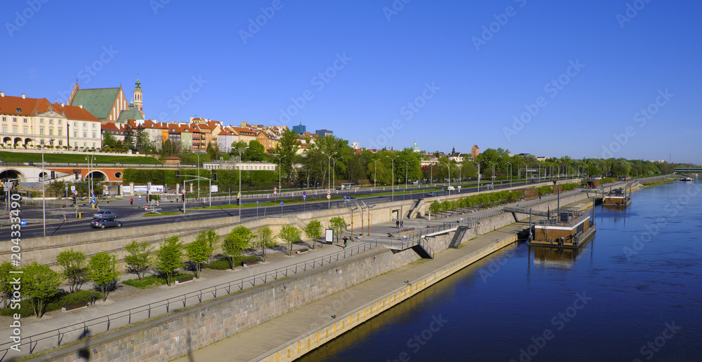 Warsaw, Poland - Panoramic view of historic quarter of Warsaw with Royal Castle and old town tenements seen from the Vistula river side