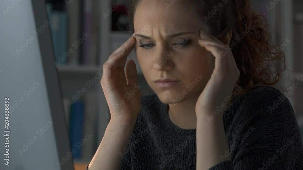 Woman with headache and aspirin dissolving in water Woman with headache and aspirin dissolving in water