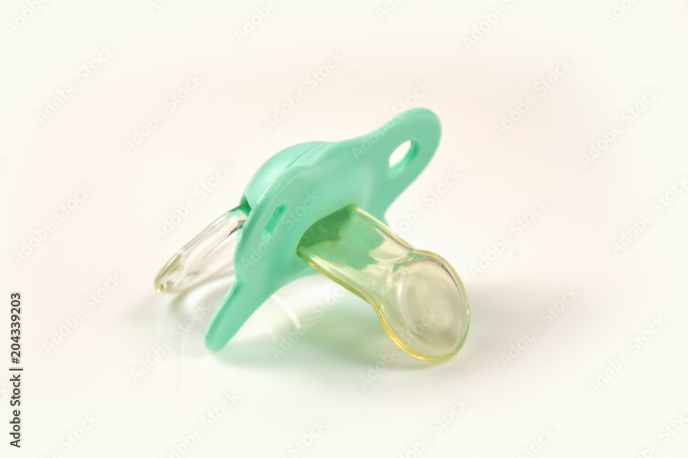 Green baby's pacifier isolated on white background Green baby's pacifier isolated on white background