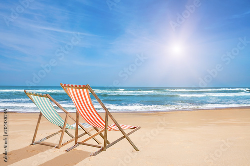 Chairs on the sandy beach near the sea. Summer holiday and vacation