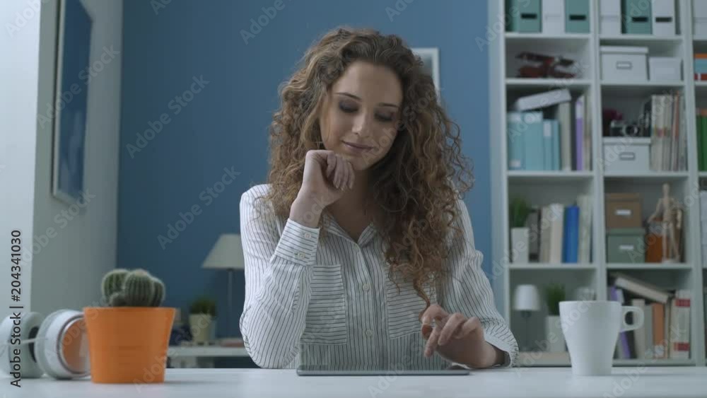 Young woman social networking with her tablet Young woman social networking with her tablet