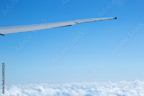 Aerial view from plane on wing and clouds