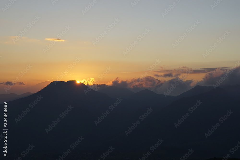 Landscape of silhouette mountains at sunrise with orange skies. Landscape of silhouette mountains at sunrise with orange skies.