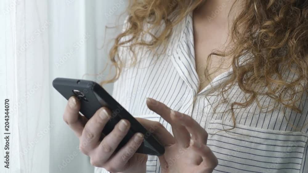 Young woman text messaging with her smartphone
