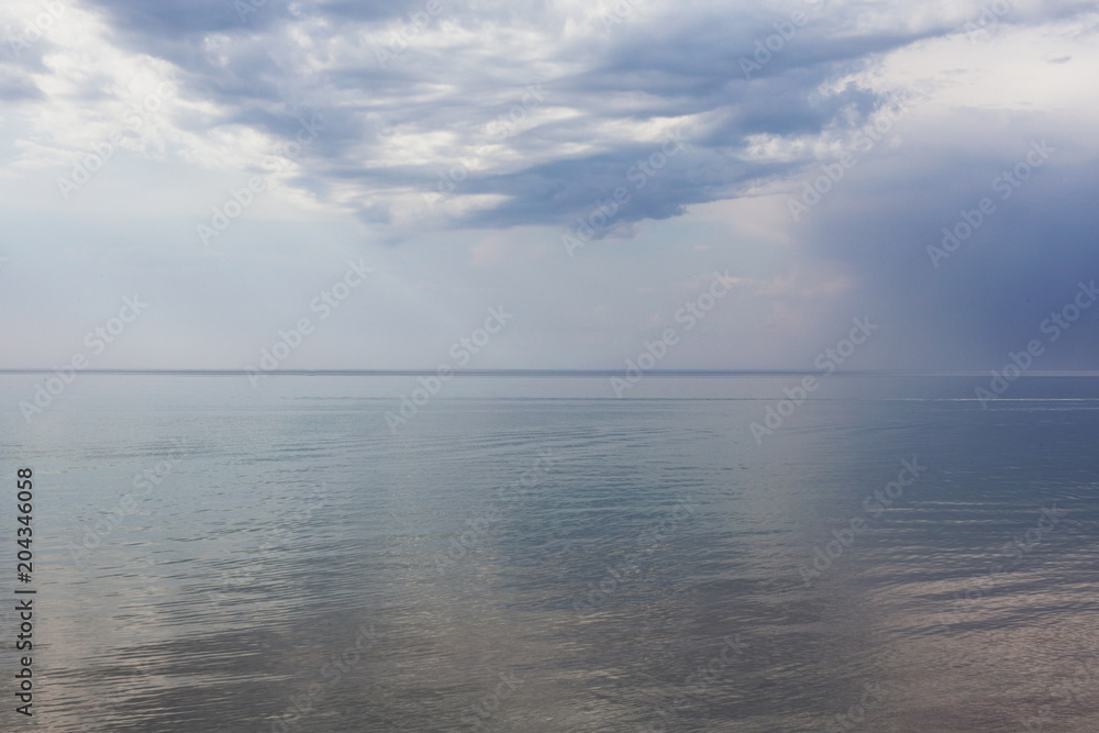 Beautiful sea landscape. The sea, the sky and clouds on the setting sun