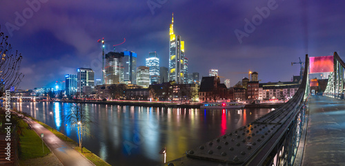 Picturesque panoramic view of business district with skyscrapers and Old Town with mirror reflections in the river during foggy morning blue hour, Frankfurt am Main, Germany
