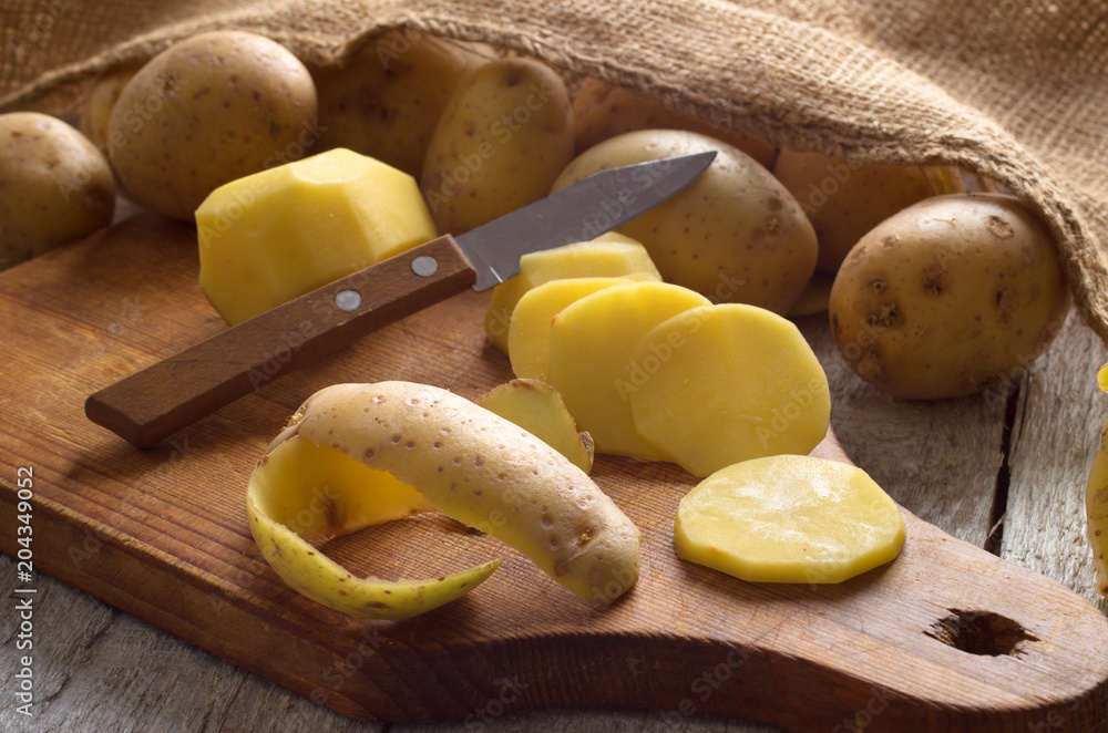 Fresh potatoes on an old wooden table