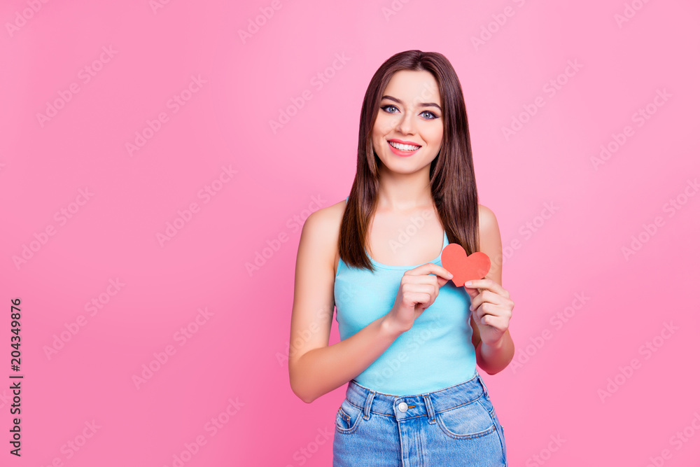 The 14th of February concept! Portrait of attractive cute dreamy charming pretty adorable gorgeous woman wearing casual blue jeans outfit giving a red heart in hands, isolated on pink background The 14th of February concept! Portrait of attractive cute dreamy charming pretty adorable gorgeous woman wearing casual blue jeans outfit giving a red heart in hands, isolated on pink background