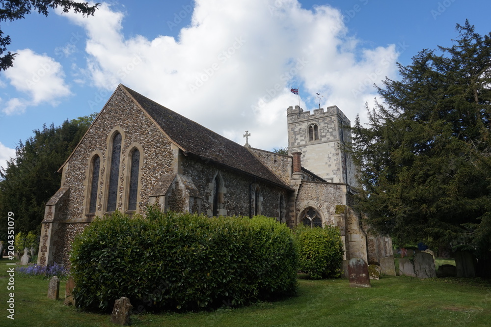 The rear side of a beautiful old stone church and a blue sky. The rear side of a beautiful old stone church and a blue sky.