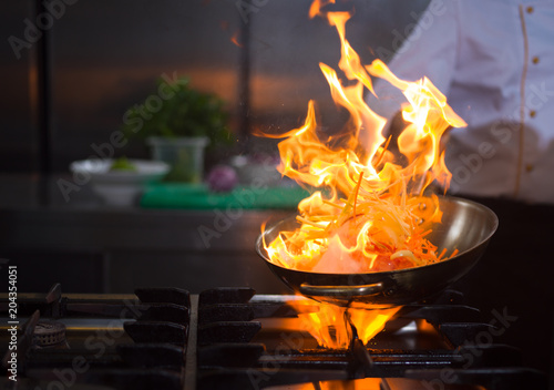 Chef doing flambe on food