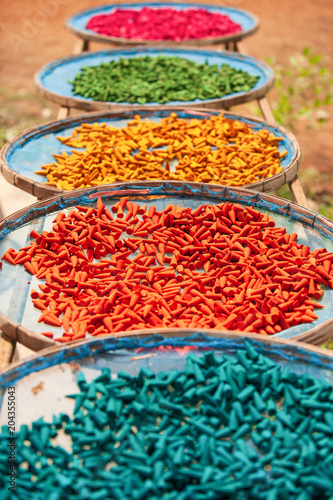 Colourful incense sticks on baskets for natural drying.