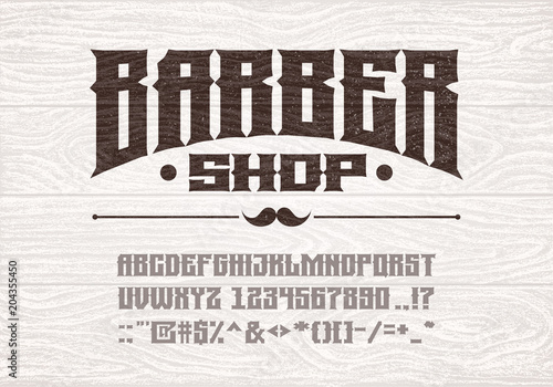 Decorative vintage bold serif font on the background of old white wooden planks