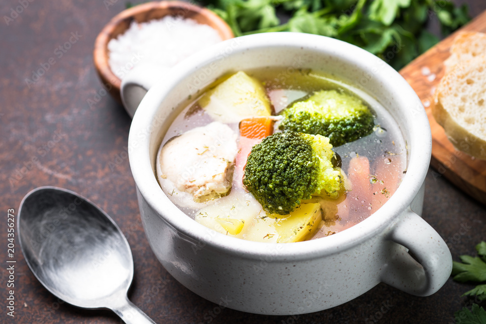Chicken and vegetables soup on dark table. Chicken and vegetables soup on dark table.