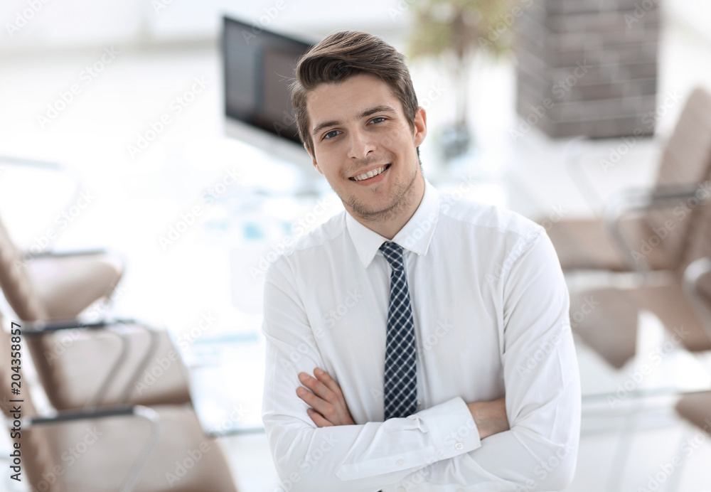confident young businessman on background of office confident young businessman on background of office