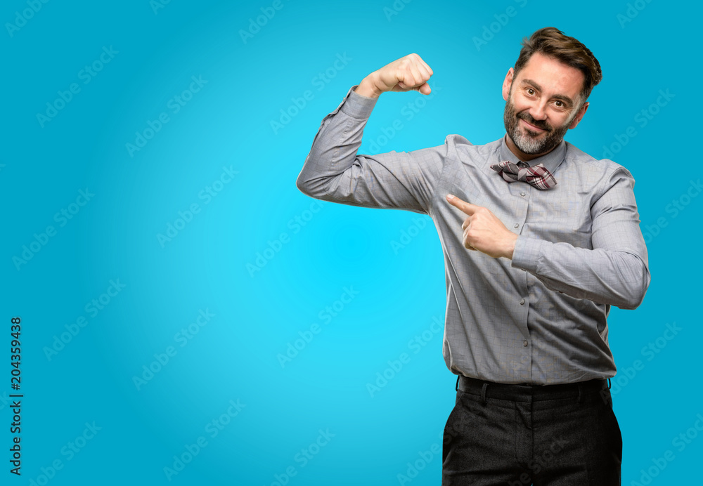 Middle age man, with beard and bow tie pointing biceps expressing strength and gym concept, healthy life its good Middle age man, with beard and bow tie pointing biceps expressing strength and gym concept, healthy life its good
