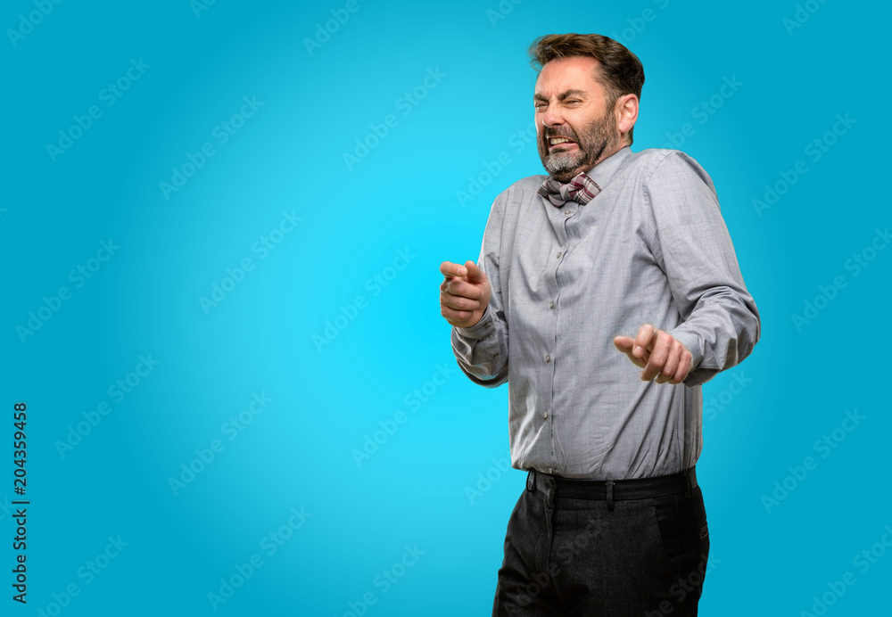 Middle age man, with beard and bow tie disgusted and angry, keeping hands in stop gesture, as a defense, shouting Middle age man, with beard and bow tie disgusted and angry, keeping hands in stop gesture, as a defense, shouting