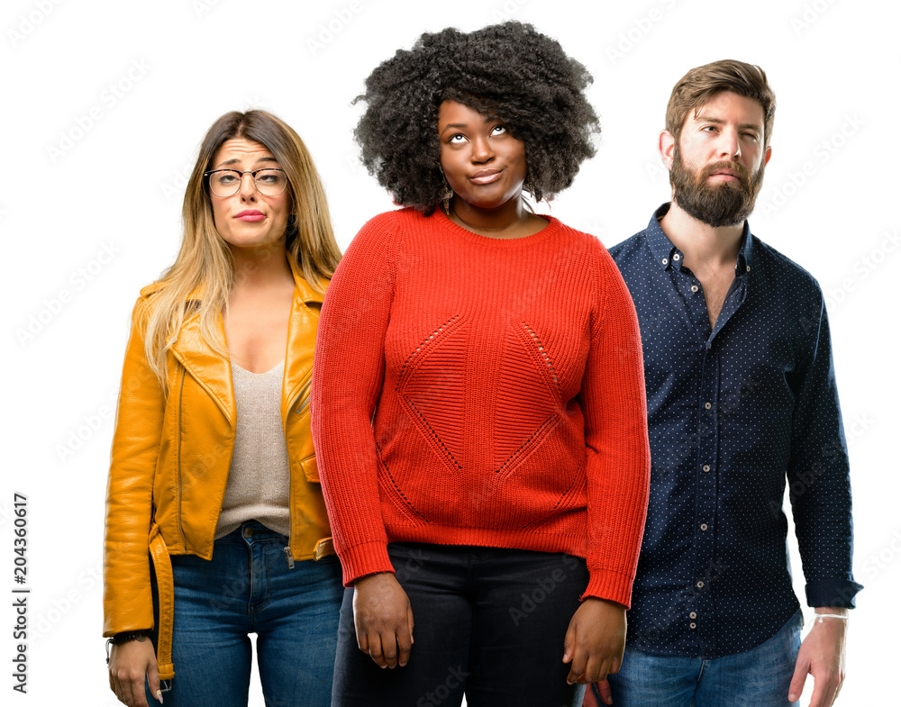Group of three young men and women making funny face fooling Group of three young men and women making funny face fooling