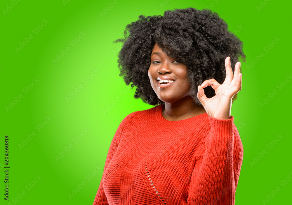 Beautiful african woman doing ok sign with hand, approve gesture Beautiful african woman doing ok sign with hand, approve gesture