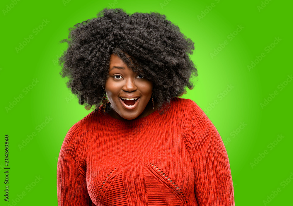 Beautiful african woman scared and surprised cheering expressing wow gesture. Unbelieving Beautiful african woman scared and surprised cheering expressing wow gesture. Unbelieving